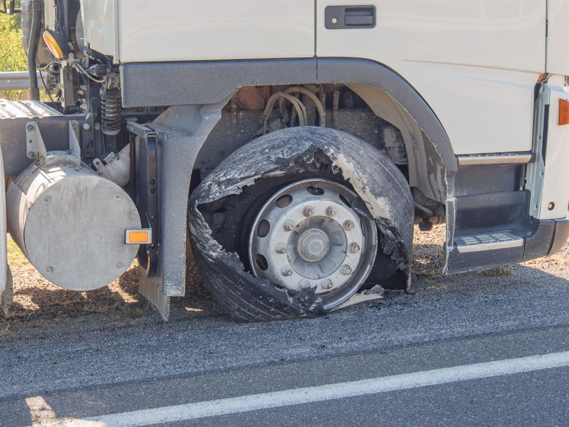 A damaged tire on a truck

Description automatically generated